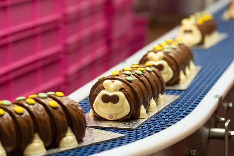 Chocolate caterpillar cakes moving along a production line at Park Cakes